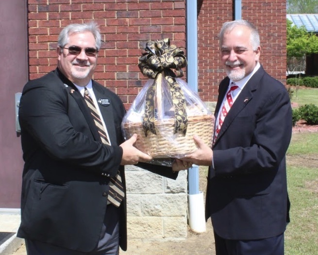picture of superintendent Waters presenting basket to superintendent Woods
